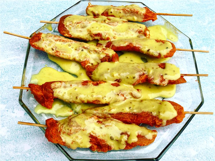 Image of Marinate the chickenArrange the chicken skewers on a flat plate...